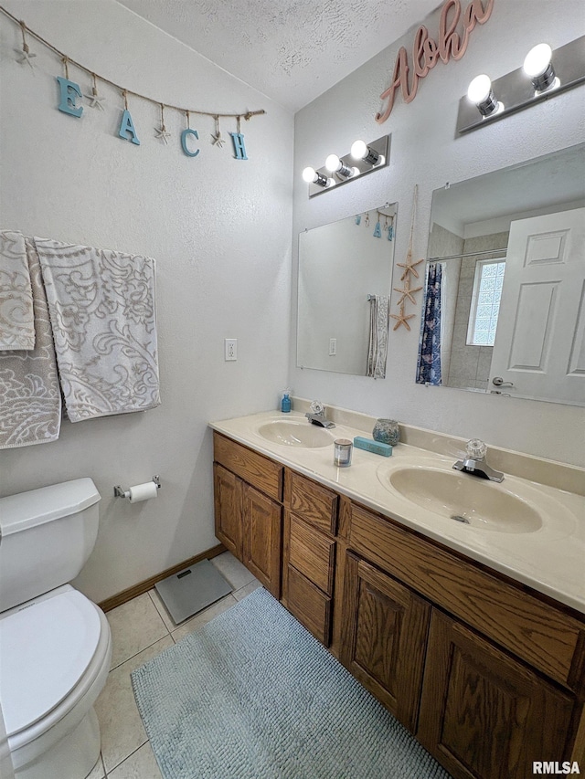 112 Townhouse Dr, Carterville, IL 62918 - full bath featuring toilet, double vanity, tile patterned floors, a textured ceiling, and a shower with curtain