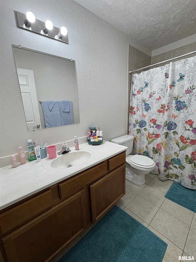 112 Townhouse Dr, Carterville, IL 62918 - bathroom featuring a textured ceiling, vanity, tile patterned floors, toilet, and a shower with curtain