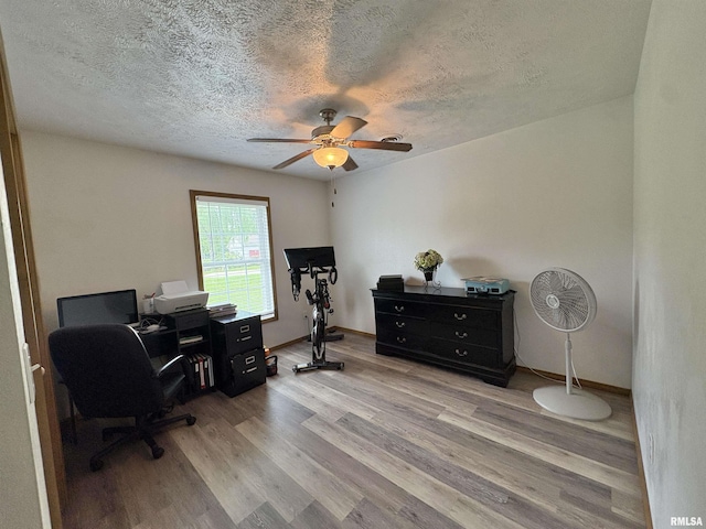 112 Townhouse Dr, Carterville, IL 62918 - home office with a ceiling fan, wood finished floors, and a textured ceiling