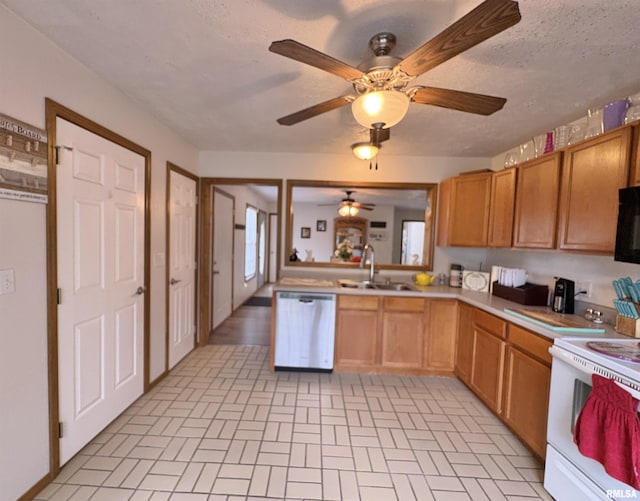 112 Townhouse Dr, Carterville, IL 62918 - kitchen with stainless steel dishwasher, a sink, white electric range oven, ceiling fan, and brick patterned floors