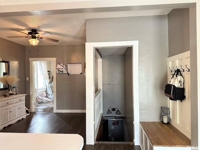 211 E Cross St, Dongola, IL 62926 - kitchen featuring dark wood-style floors, ceiling fan, white cabinets, baseboards, and light countertops