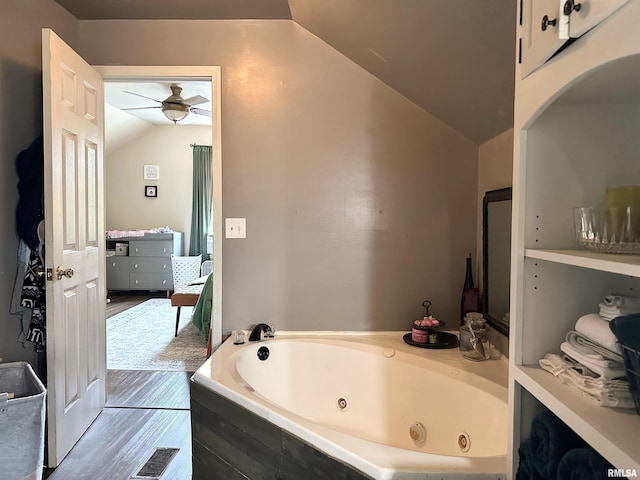 211 E Cross St, Dongola, IL 62926 - bathroom with lofted ceiling, a whirlpool tub, ceiling fan, and wood finished floors