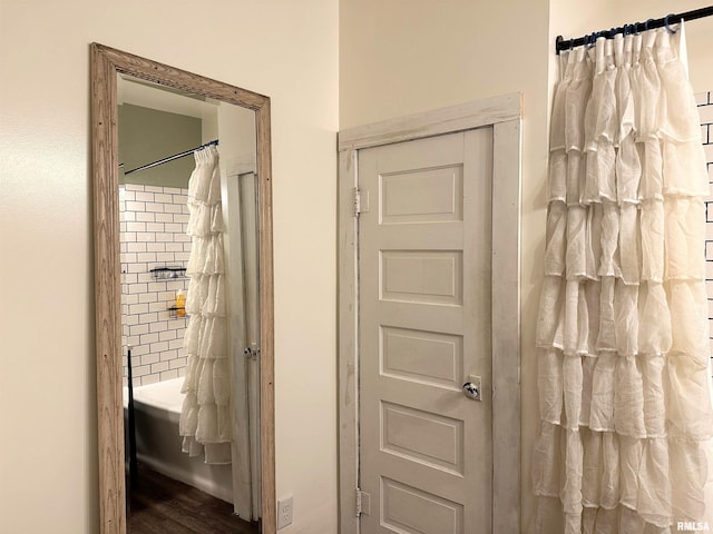 211 E Cross St, Dongola, IL 62926 - full bathroom with wood finished floors and shower / bath combo with shower curtain