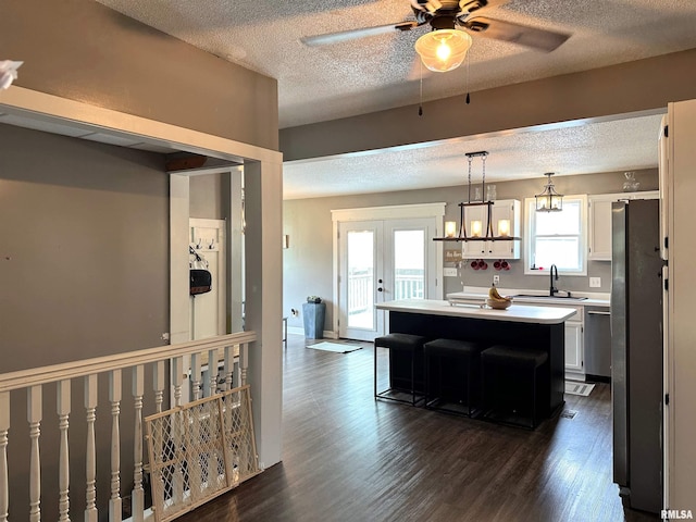 211 E Cross St, Dongola, IL 62926 - kitchen featuring a ceiling fan, a center island, white cabinets, dark wood-type flooring, and a textured ceiling