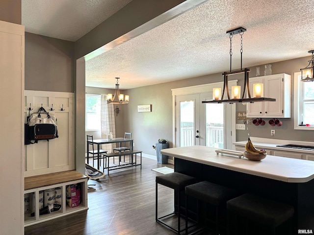 211 E Cross St, Dongola, IL 62926 - kitchen with a chandelier, a textured ceiling, white cabinetry, light countertops, and dark wood-style floors