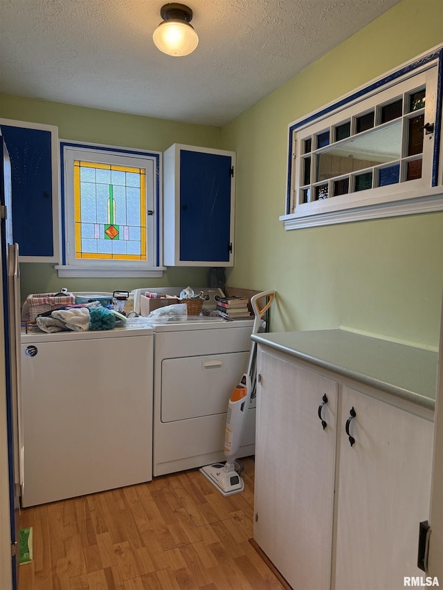 2016 Greenview St, Metropolis, IL 62960 - washroom with cabinet space, washer and clothes dryer, light wood finished floors, and a textured ceiling