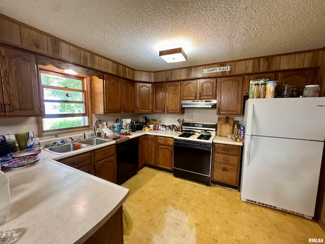 2601 Nielson Crossing Rd, Marion, IL 62959 - kitchen with freestanding refrigerator, gas stove, under cabinet range hood, black dishwasher, and a sink