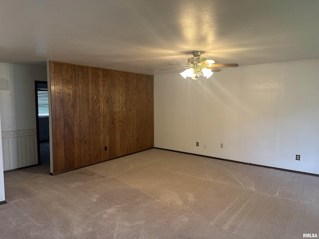 705 Terrace Dr, Duquoin, IL 62832 - unfurnished room with a ceiling fan, light carpet, wood walls, and baseboards