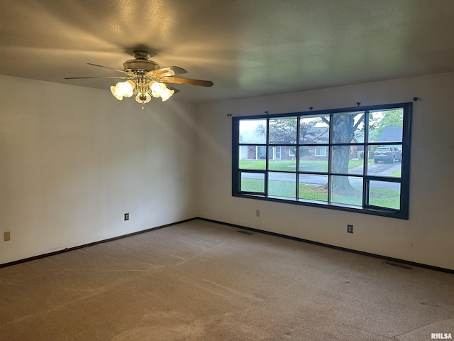 705 Terrace Dr, Duquoin, IL 62832 - spare room featuring a ceiling fan, light carpet, and baseboards