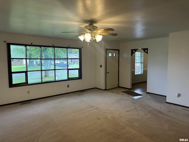 705 Terrace Dr, Duquoin, IL 62832 - unfurnished living room featuring light carpet, baseboards, and a ceiling fan