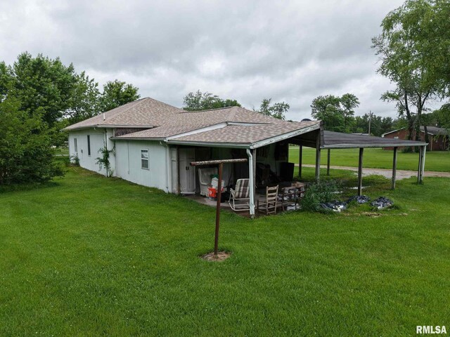 11218 Old Lake Rd, Benton, IL 62812 - back of property featuring roof with shingles and a lawn