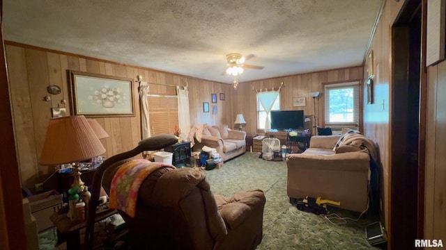 11218 Old Lake Rd, Benton, IL 62812 - living room with carpet flooring, wood walls, a ceiling fan, a textured ceiling, and ornamental molding
