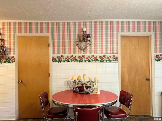 1011 W Goodall St, Marion, IL 62959 - dining space featuring wallpapered walls, tile walls, and a textured ceiling