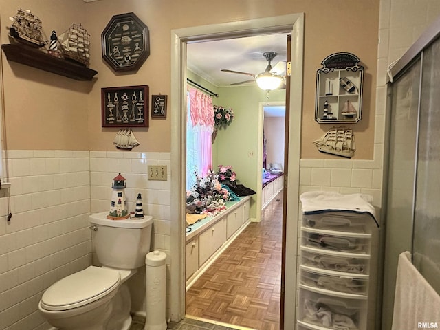 1011 W Goodall St, Marion, IL 62959 - bathroom featuring tile walls, toilet, a ceiling fan, a wainscoted wall, and crown molding