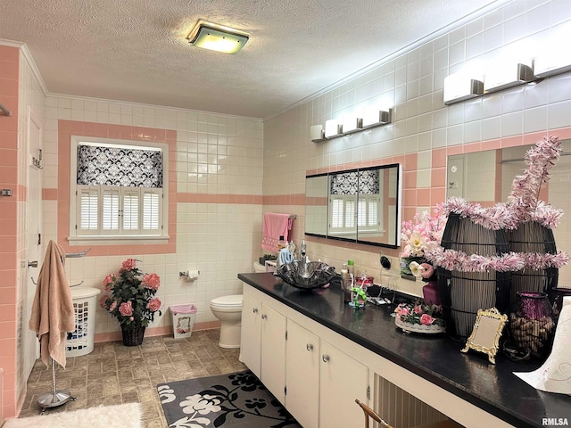 1011 W Goodall St, Marion, IL 62959 - bathroom with ornamental molding, toilet, vanity, tile walls, and a textured ceiling