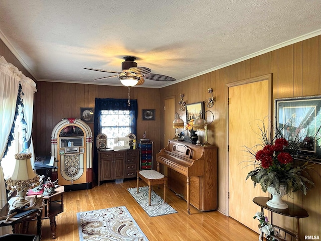 1011 W Goodall St, Marion, IL 62959 - foyer entrance featuring ceiling fan, ornamental molding, light wood finished floors, wood walls, and a textured ceiling