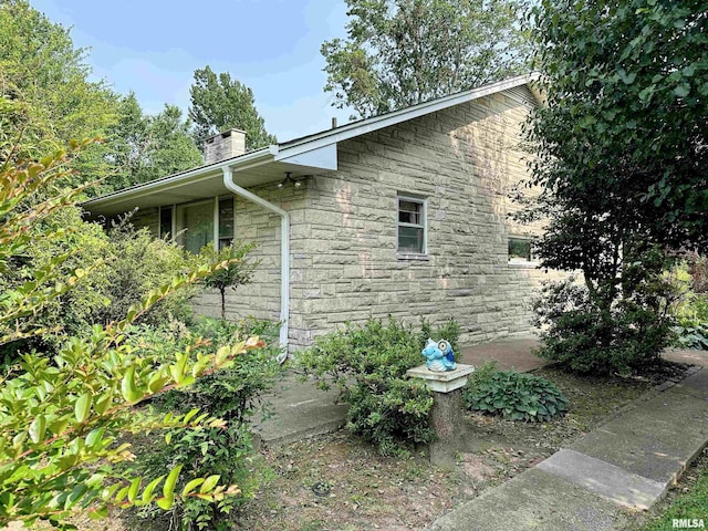 1011 W Goodall St, Marion, IL 62959 - view of home's exterior featuring stone siding and a chimney