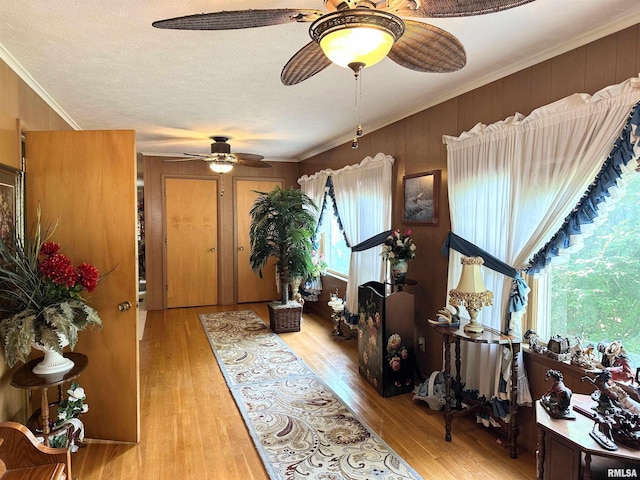 1011 W Goodall St, Marion, IL 62959 - foyer entrance with a ceiling fan, ornamental molding, wood finished floors, wood walls, and a textured ceiling
