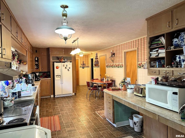 1011 W Goodall St, Marion, IL 62959 - kitchen with white appliances, light countertops, brick patterned flooring, brown cabinets, and hanging light fixtures