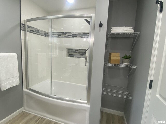421 N 10th St, Benton, IL 62812 - full bath with wood finished floors, baseboards, and shower / bath combination with glass door