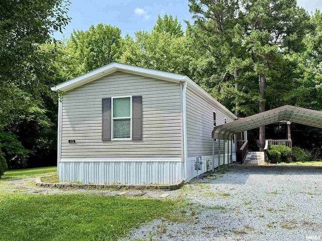 113 E 21st St, Metropolis, IL 62960 - view of side of property with a detached carport and gravel driveway