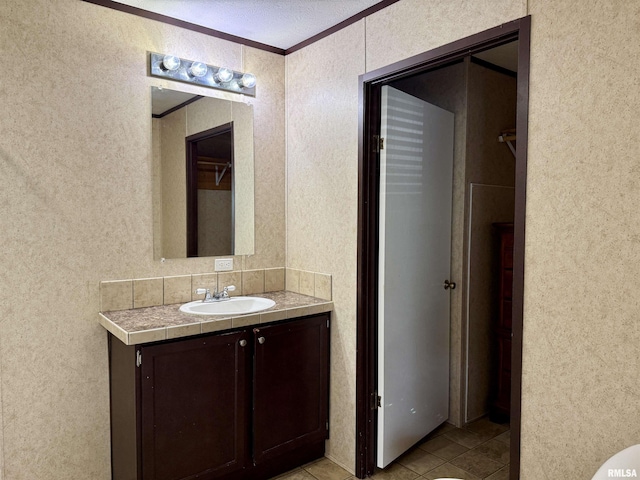 113 E 21st St, Metropolis, IL 62960 - bathroom with vanity, crown molding, tile patterned floors, and a textured wall