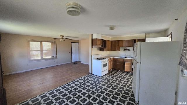 101 Diamond St, Mound City, IL 62963 - kitchen with white appliances, a sink, dark flooring, light countertops, and baseboards
