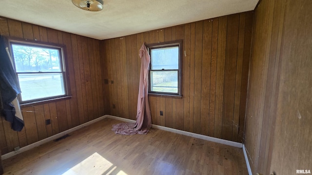 101 Diamond St, Mound City, IL 62963 - unfurnished room with healthy amount of natural light, wood finished floors, baseboards, and wooden walls