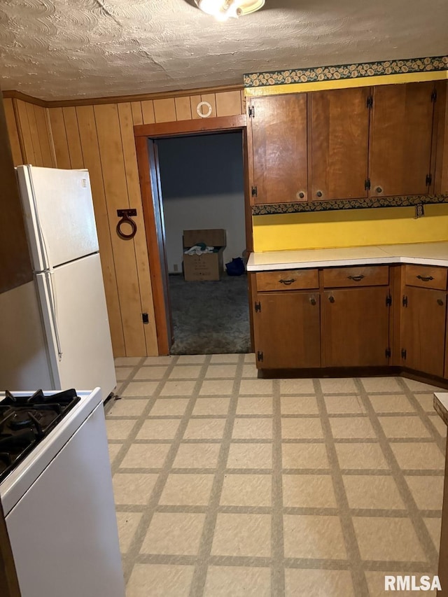 1606 W Faust St, Marion, IL 62959 - kitchen featuring freestanding refrigerator, stove, light countertops, a textured ceiling, and brown cabinetry