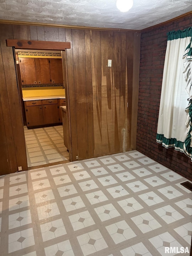 1606 W Faust St, Marion, IL 62959 - empty room with brick wall, wooden walls, and light floors