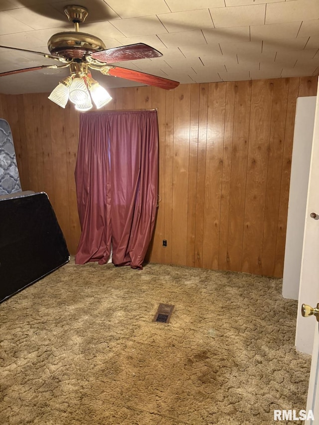 1606 W Faust St, Marion, IL 62959 - unfurnished room featuring carpet, wood walls, and a ceiling fan