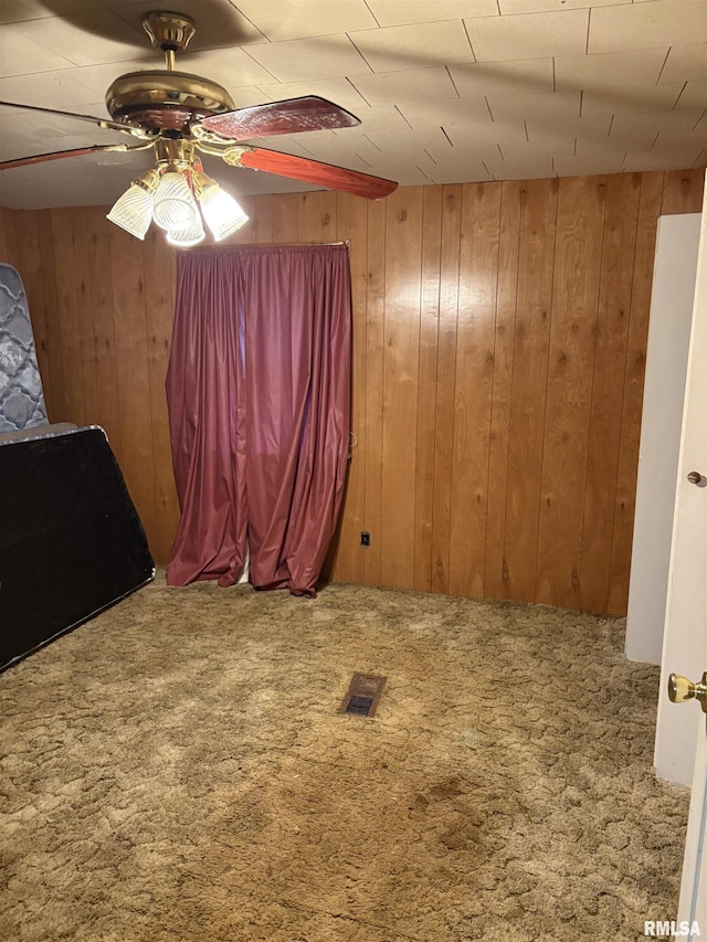 1606 W Faust St, Marion, IL 62959 - unfurnished room featuring carpet flooring, wood walls, and a ceiling fan