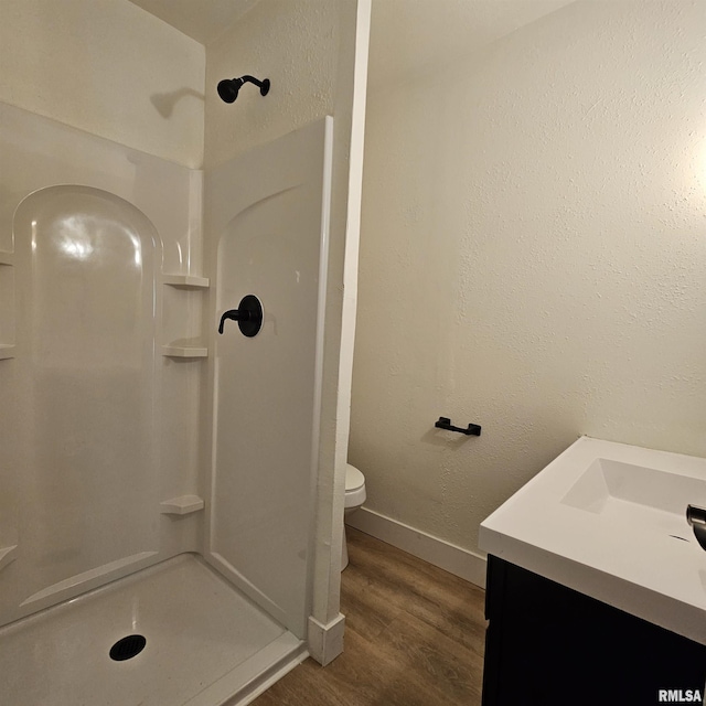 15074 N Mccauley Ln, Mount Vernon, IL 62864 - bathroom with a shower, vanity, wood finished floors, toilet, and baseboards
