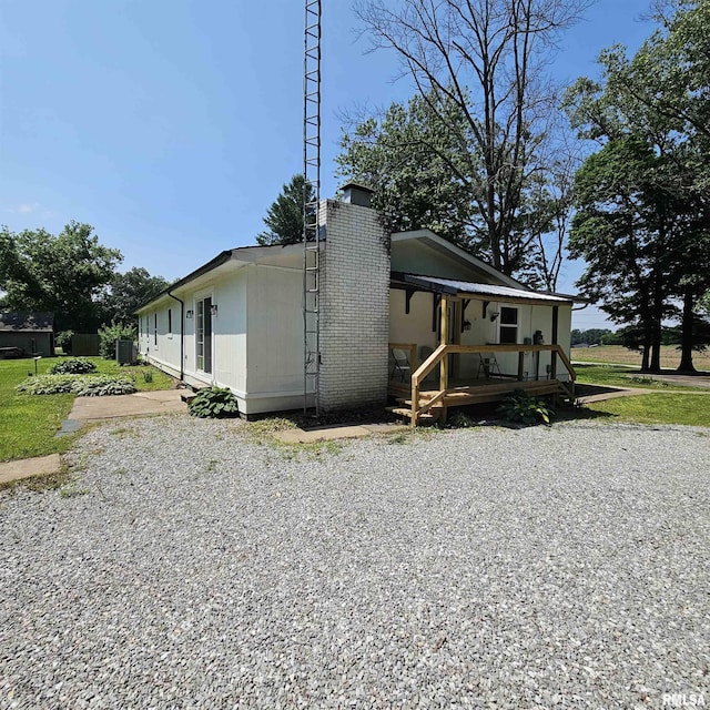 15074 N Mccauley Ln, Mount Vernon, IL 62864 - view of property exterior with a chimney, central AC unit, and a porch