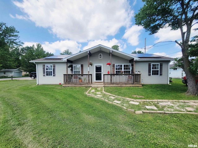 100 Stable Dr, Carterville, IL 62918 - view of front of home with solar panels, a deck, and a front yard