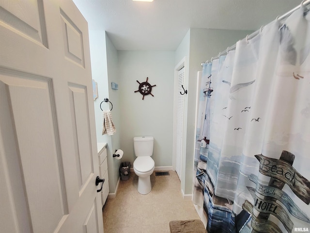 100 Stable Dr, Carterville, IL 62918 - bathroom with toilet, vanity, tile patterned flooring, baseboards, and curtained shower