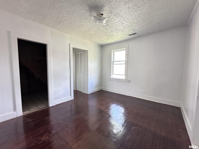 329 N Broadway Ave, Goreville, IL 62939 - unfurnished room with baseboards and dark wood-type flooring