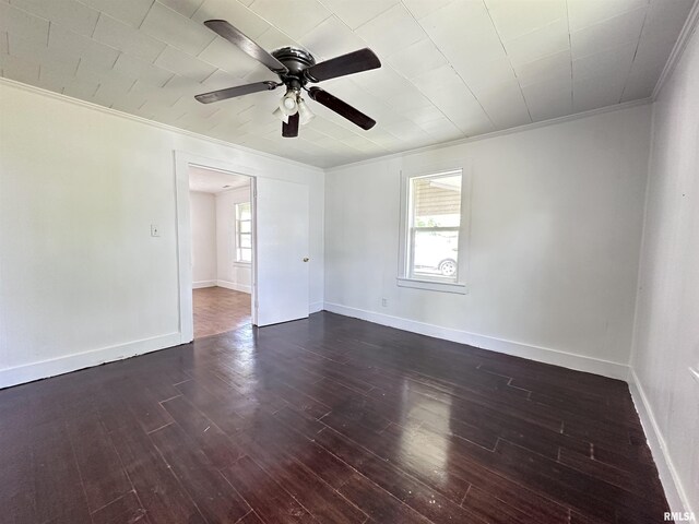 329 N Broadway Ave, Goreville, IL 62939 - unfurnished room with crown molding, a ceiling fan, dark wood-type flooring, and baseboards