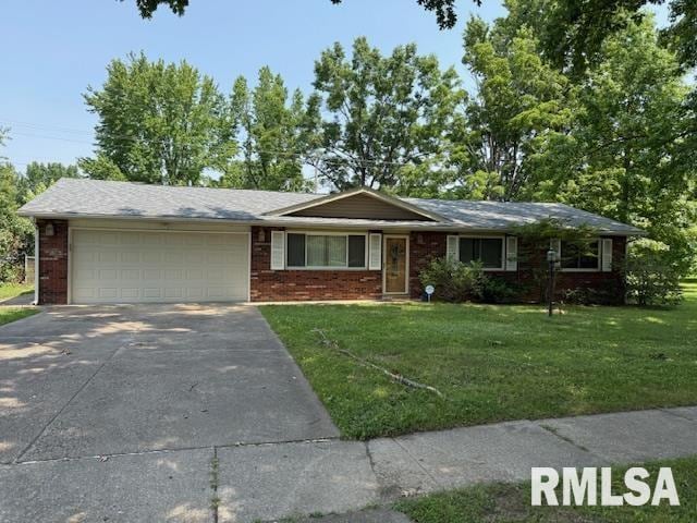 1700 W Taylor Dr, Carbondale, IL 62901 - ranch-style home featuring an attached garage, concrete driveway, a front lawn, and brick siding