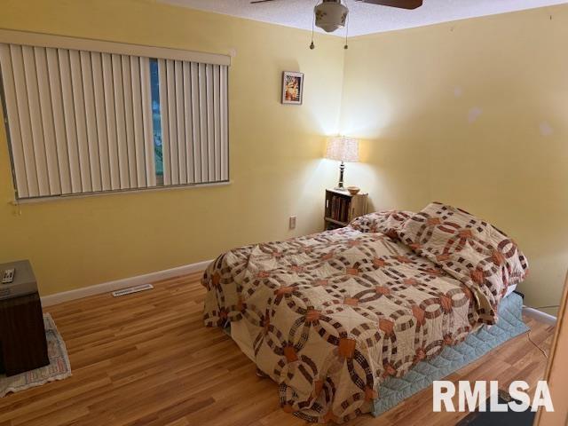 1700 W Taylor Dr, Carbondale, IL 62901 - bedroom featuring wood finished floors, baseboards, and ceiling fan