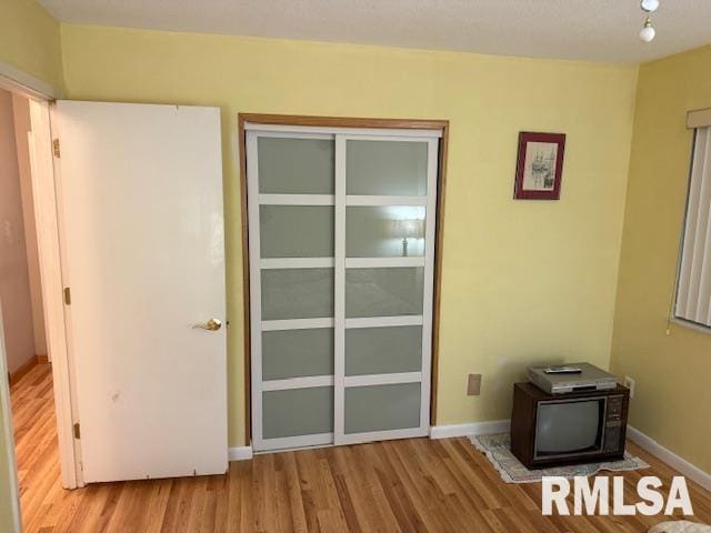 1700 W Taylor Dr, Carbondale, IL 62901 - interior space featuring wood finished floors, baseboards, a closet, and a wood stove