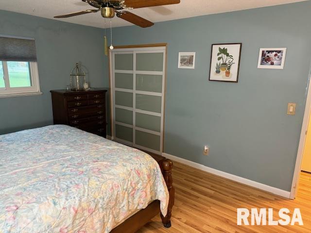 1700 W Taylor Dr, Carbondale, IL 62901 - bedroom with wood finished floors, baseboards, and ceiling fan