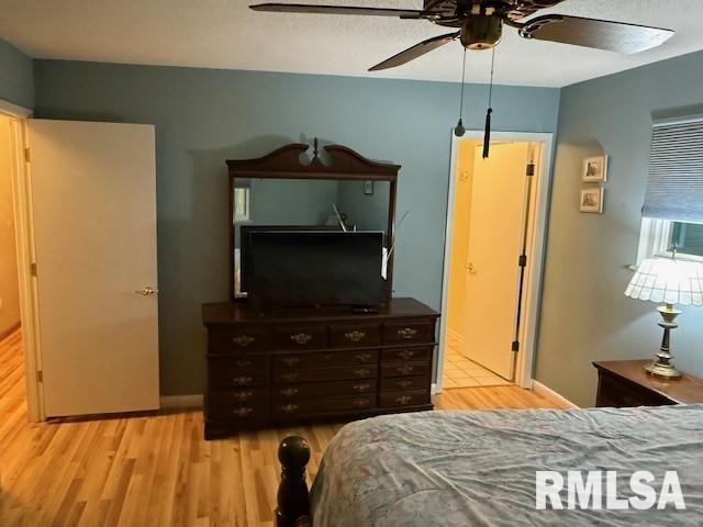 1700 W Taylor Dr, Carbondale, IL 62901 - bedroom with wood finished floors, ceiling fan, and baseboards