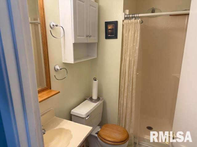 1700 W Taylor Dr, Carbondale, IL 62901 - bathroom featuring a stall shower, toilet, and vanity