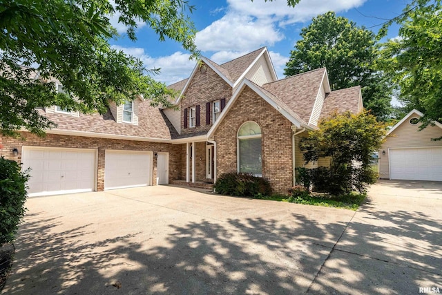 1803 N Dawn Dr, Marion, IL 62959 - traditional-style house with brick siding, driveway, roof with shingles, and a garage