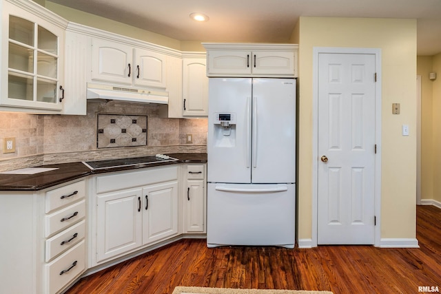 1803 N Dawn Dr, Marion, IL 62959 - kitchen with white refrigerator with ice dispenser, black electric cooktop, under cabinet range hood, dark countertops, and dark wood finished floors