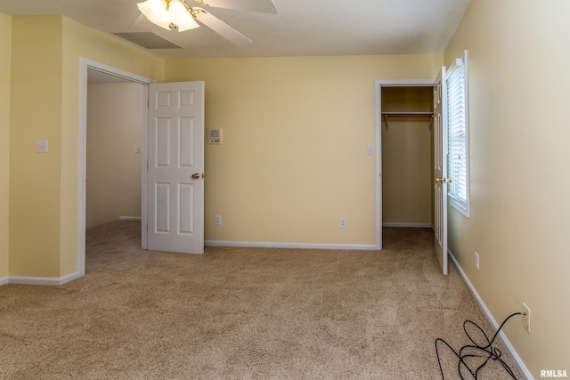 1803 N Dawn Dr, Marion, IL 62959 - unfurnished bedroom featuring carpet flooring, a closet, a walk in closet, and ceiling fan