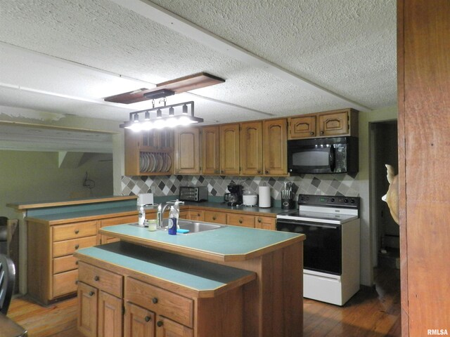 4370 Buncombe Rd, Vienna, IL 62995 - kitchen featuring black microwave, electric range, brown cabinets, wood finished floors, and a kitchen island with sink