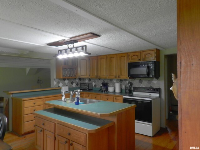 4370 Buncombe Rd, Vienna, IL 62995 - kitchen featuring black microwave, electric range oven, light wood-style flooring, a textured ceiling, and a center island with sink