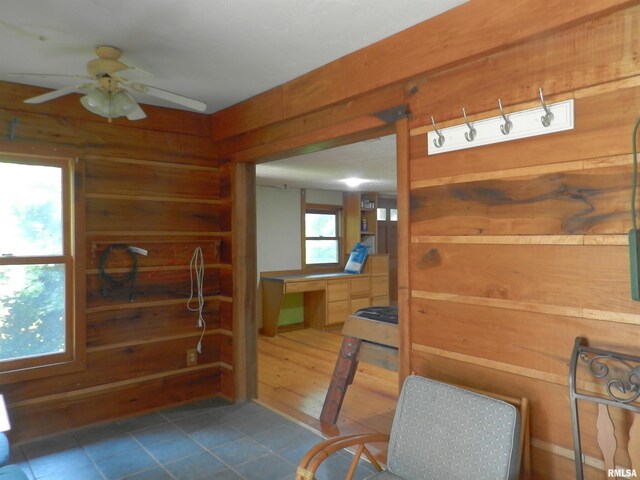 4370 Buncombe Rd, Vienna, IL 62995 - interior space featuring wood walls, tile patterned flooring, and ceiling fan